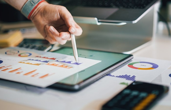 An individual uses a pen to create drawings on a tablet, showcasing technology's role in RFP management.
